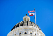 Democratic CHAOS: California Governor’s Mansion at Risk View of a state capitol dome with American and California flags against a blue sky