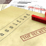 A collection of classified documents with a red 'Top Secret' stamp