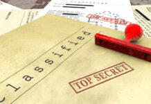 A collection of classified documents with a red 'Top Secret' stamp