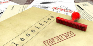 A collection of classified documents with a red 'Top Secret' stamp