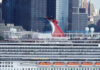 Carnival Horizon cruise ship docked near a city skyline