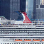 Carnival Horizon cruise ship docked near a city skyline