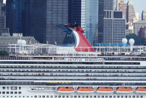 Carnival Horizon cruise ship docked near a city skyline