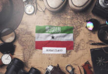 Mystery Base Offer: Will U.S. Risk It? Somaliland flag placed on a vintage map surrounded by travel items