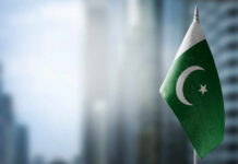 Fuel Rationing Chaos Hits Pakistan Flag of Pakistan waving in a blurred urban background