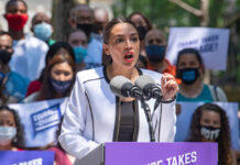 A speaker passionately addressing a crowd at a political rally