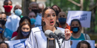A speaker passionately addressing a crowd at a political rally