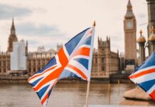 British flags in the foreground with the Houses of Parliament and Big Ben in the background