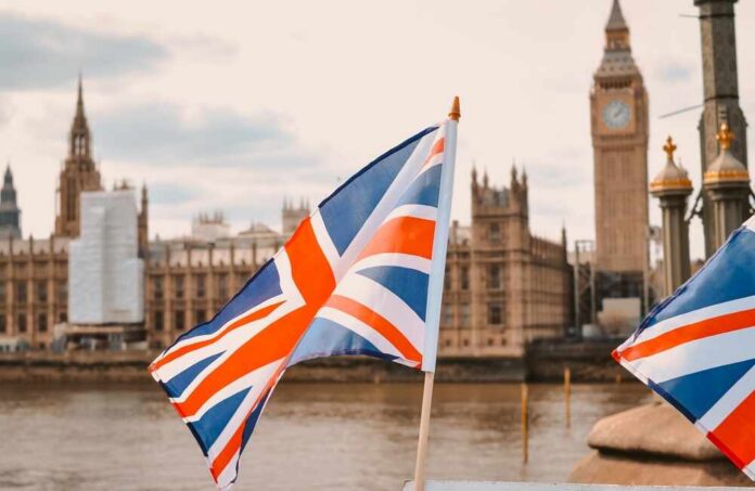 British flags in the foreground with the Houses of Parliament and Big Ben in the background