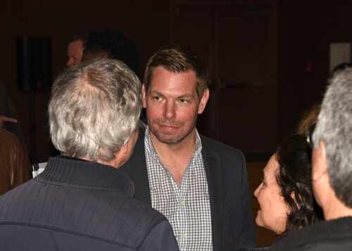 shutterstock_2270027987.jpg Group of people engaged in conversation at an event