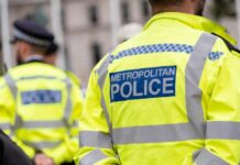 Uniformed Metropolitan Police officers standing in a public area