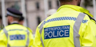 Uniformed Metropolitan Police officers standing in a public area