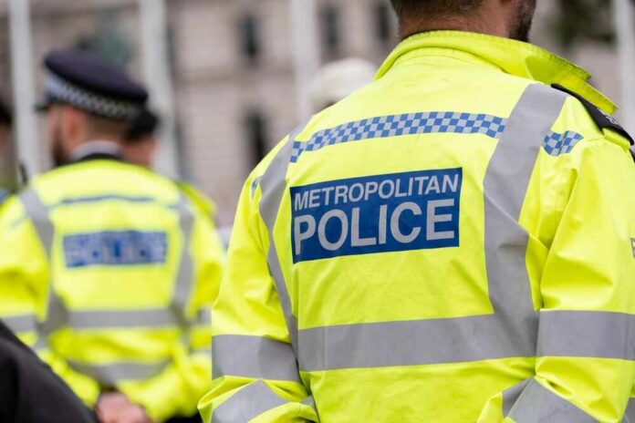 Uniformed Metropolitan Police officers standing in a public area