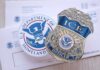 ICE badge and U.S. Department of Homeland Security emblem on official documents