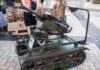 A robotic military vehicle equipped with a mounted gun on display