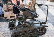A robotic military vehicle equipped with a mounted gun on display