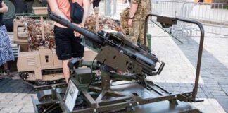 A robotic military vehicle equipped with a mounted gun on display