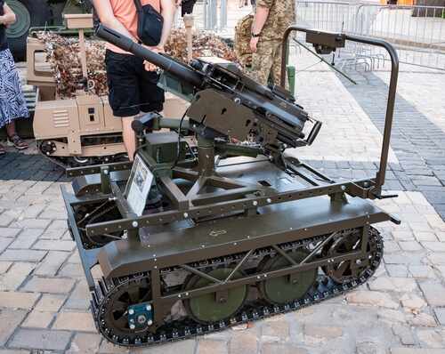 A robotic military vehicle equipped with a mounted gun on display