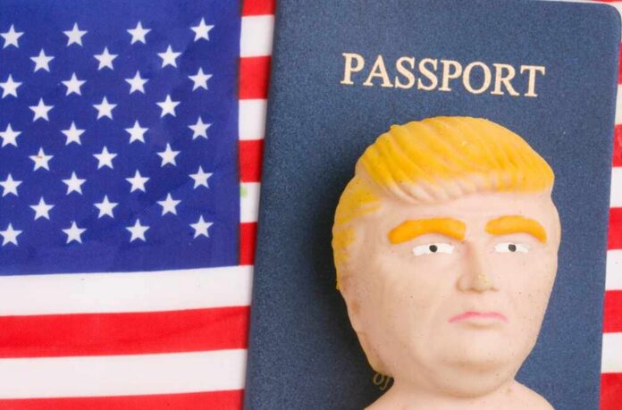 A humorous figurine resembling a political figure next to a passport on an American flag background