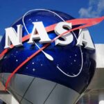 NASA logo displayed on a large blue globe against a clear sky