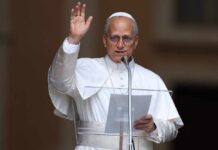 Religious leader giving a speech outdoors with a raised hand