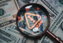Magnifying glass over U.S. dollar bills with a scam warning