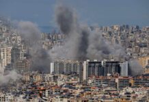 Smoke rising from buildings in a densely populated urban area
