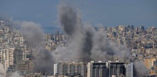 Smoke rising from buildings in a densely populated urban area