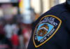 Close-up of a New York City police badge on a uniform