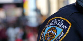 Close-up of a New York City police badge on a uniform