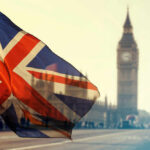 Union Jack flag waving in front of Big Ben in London