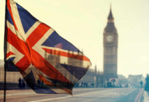 Union Jack flag waving in front of Big Ben in London