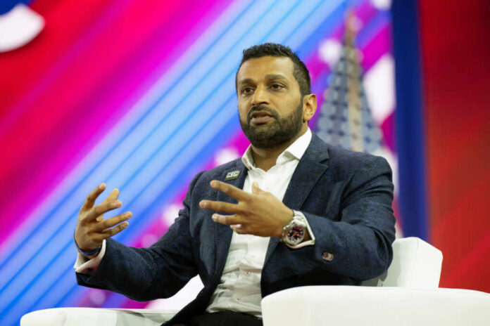 A speaker in a blue blazer passionately discussing on stage at a conference