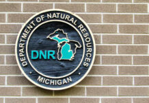 Sign of the Michigan Department of Natural Resources on a brick wall