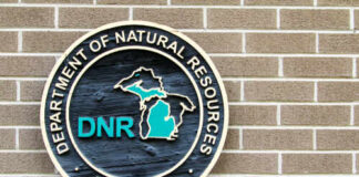 Sign of the Michigan Department of Natural Resources on a brick wall