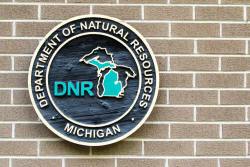 Sign of the Michigan Department of Natural Resources on a brick wall