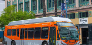 Metro Local bus in orange and silver parked on a city street