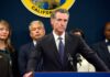 California officials at a press conference with a speaker at the podium