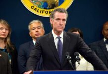 California officials at a press conference with a speaker at the podium