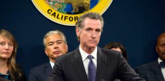 California officials at a press conference with a speaker at the podium