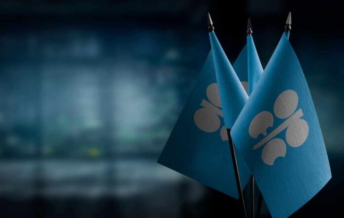 Three blue flags with a silver emblem on a blurred background