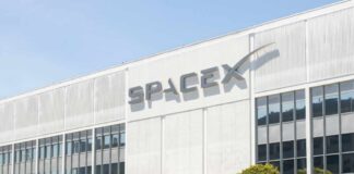 Exterior view of the SpaceX building with a prominent logo