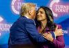 Two public figures embracing at a political conference
