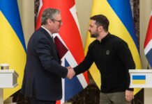 Two political leaders shaking hands during a meeting