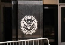 DHS vs. Protesters: ‘Not Holiday Inn!’ Clash Emblem of the U.S. Department of Homeland Security on a building