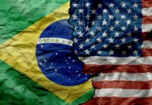 Brazil and United States flags split by a jagged tear