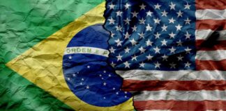 Brazil and United States flags split by a jagged tear