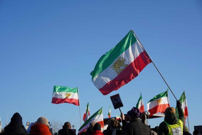 Crowd holding Iranian flags during a protest against the government