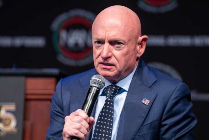 A man in a suit speaking into a microphone at a conference