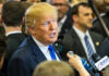 Perjury Threat Looms in Trump Legal Tangle A man speaking to reporters at a press event surrounded by media personnel